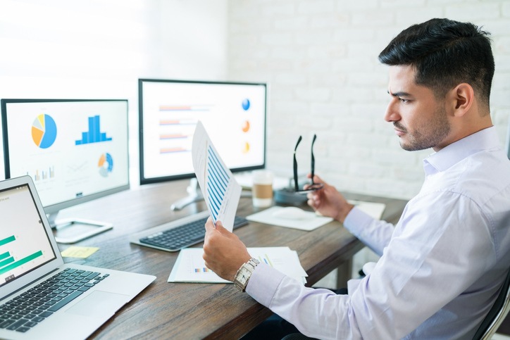 Handsome Latin Businessman Examining Sales Data
