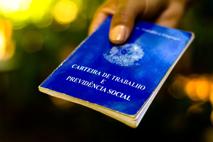 Woman holds his Brazilian document work and social security (Carteira de Trabalho e Previdencia Social)