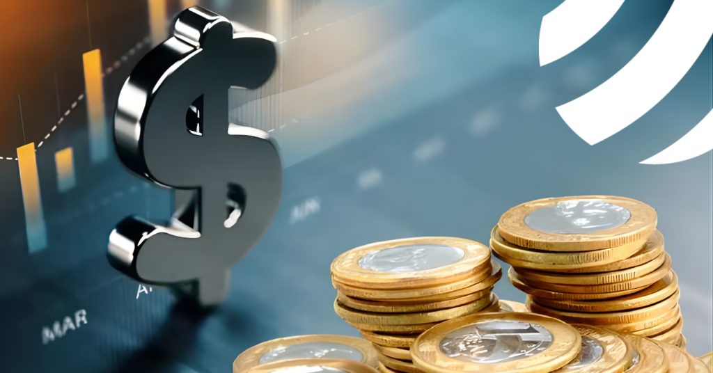 Símbolo de dinheiro e moedas de Real em frente a gráficos de mercado, representando a economia brasileira e as mudanças fiscais da Reforma Tributária.